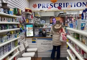 dolphin digital ooh screen displaying ad in pharmacy