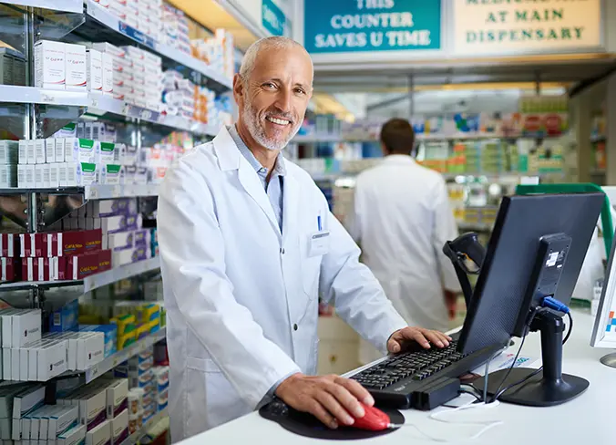 Mature pharmacist checking daily cash report from Rx Assassins