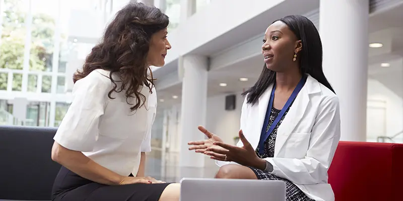 female pharmacist talking to head of clinic