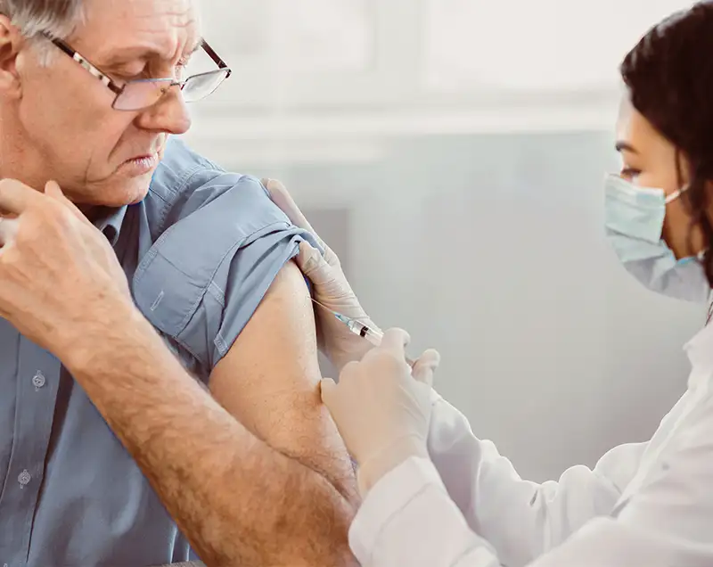 pharmacist giving patient a vaccine