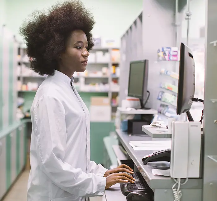 pharmacist improving pharmacy workflow at computer